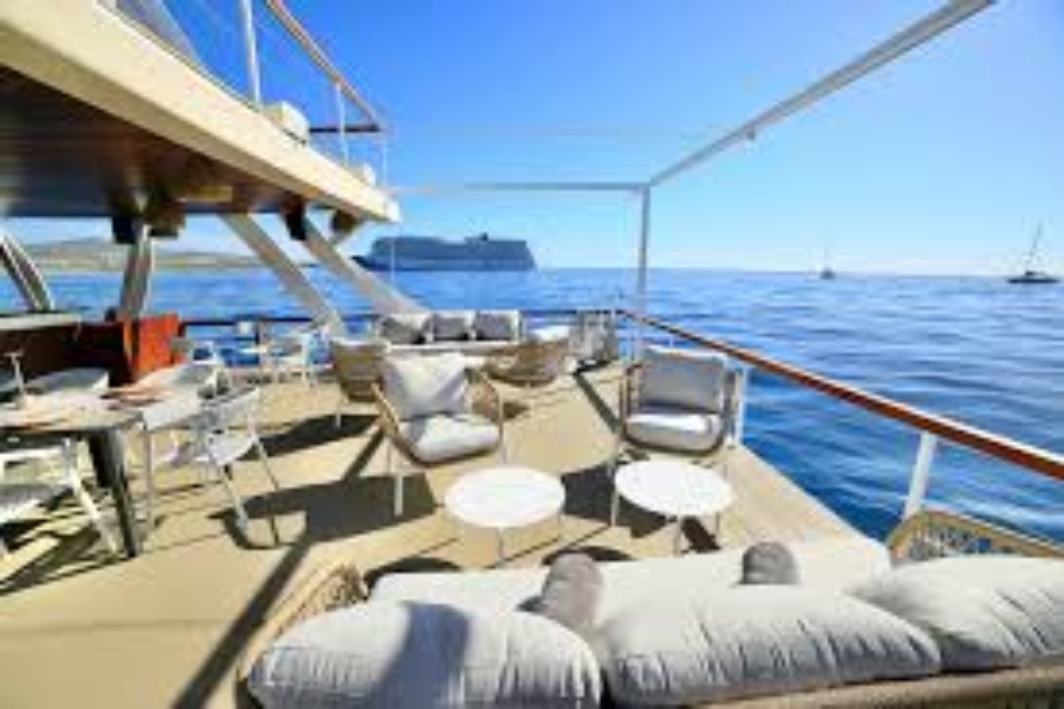 Open deck lounge with sofas and tables on a Cabo event catamaran