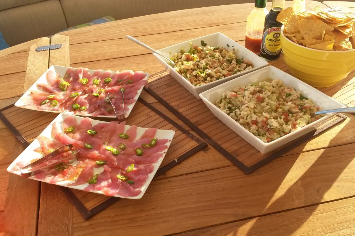 Fresh appetizers served on the deck table of a Cabo charter catamaran