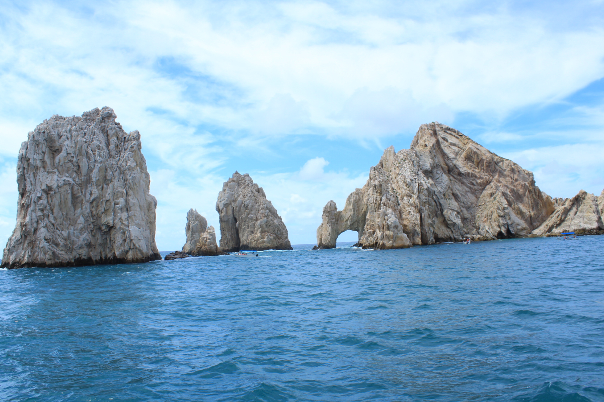 The Arch and the sea stacks of Land's End seen from the water